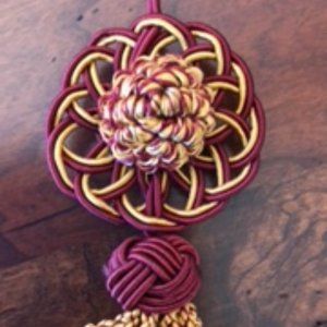 Three Burgundy and Gold Decorative Tassels